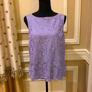 Lavender blouse with embroidered detailing on front.